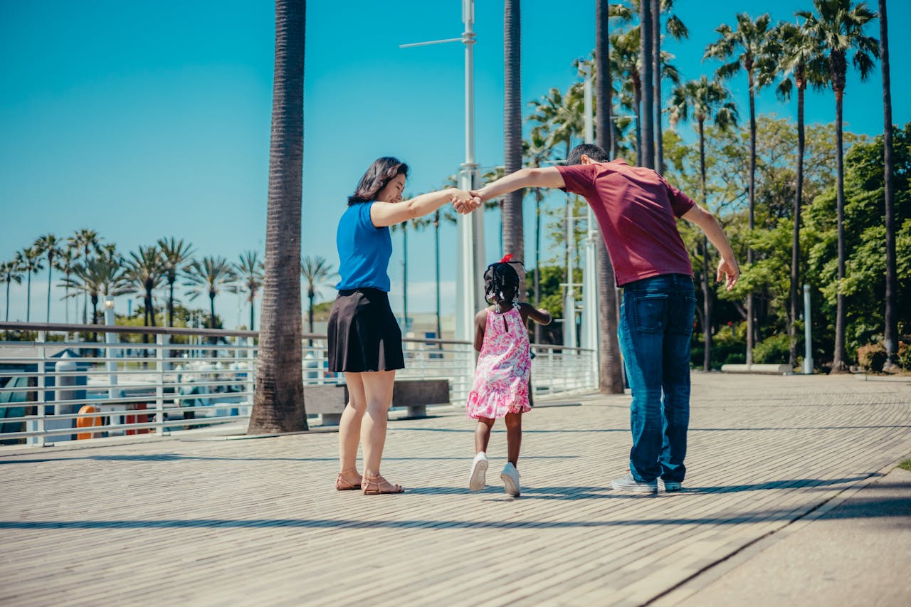 A joyful family enjoying a walk outdoors under sunny skies, fostering togetherness.