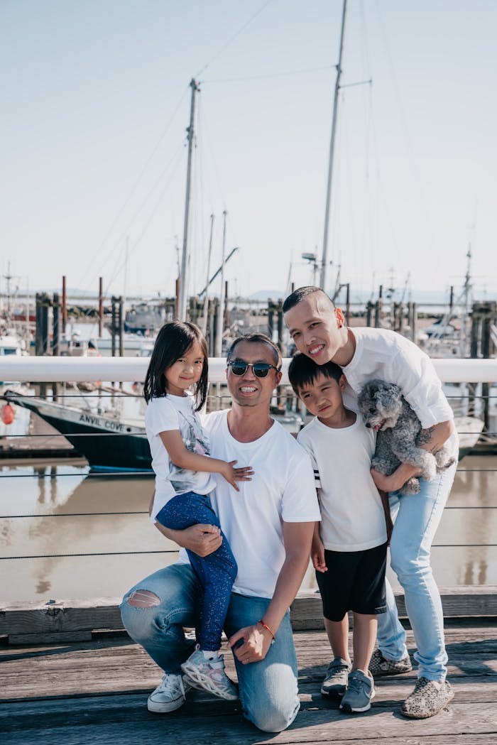 Family enjoying a day at the marina with their dog. Smiling and joyful atmosphere.